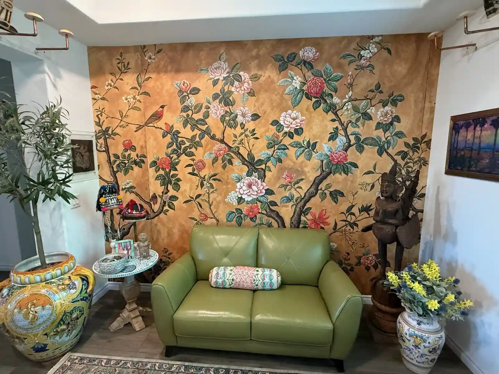 Blue floral mural wallpaper across a feature wall in a dark room