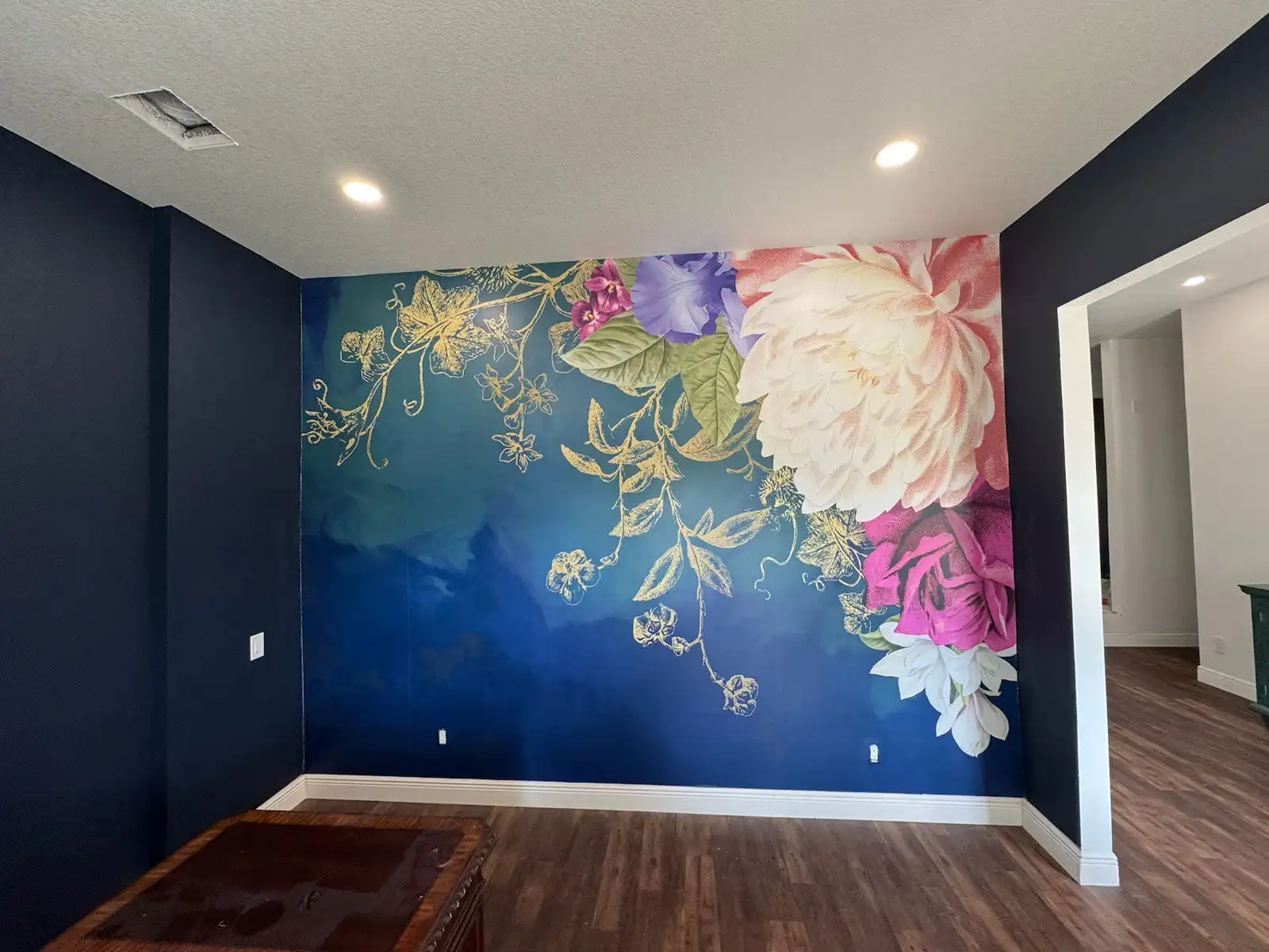 Framed dark botanical wallpaper panels in a hallway