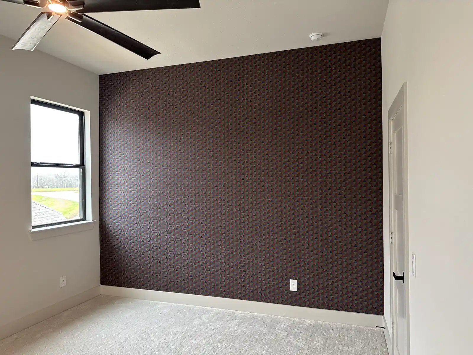 Textured neutral wallcovering with a broad repeating pattern